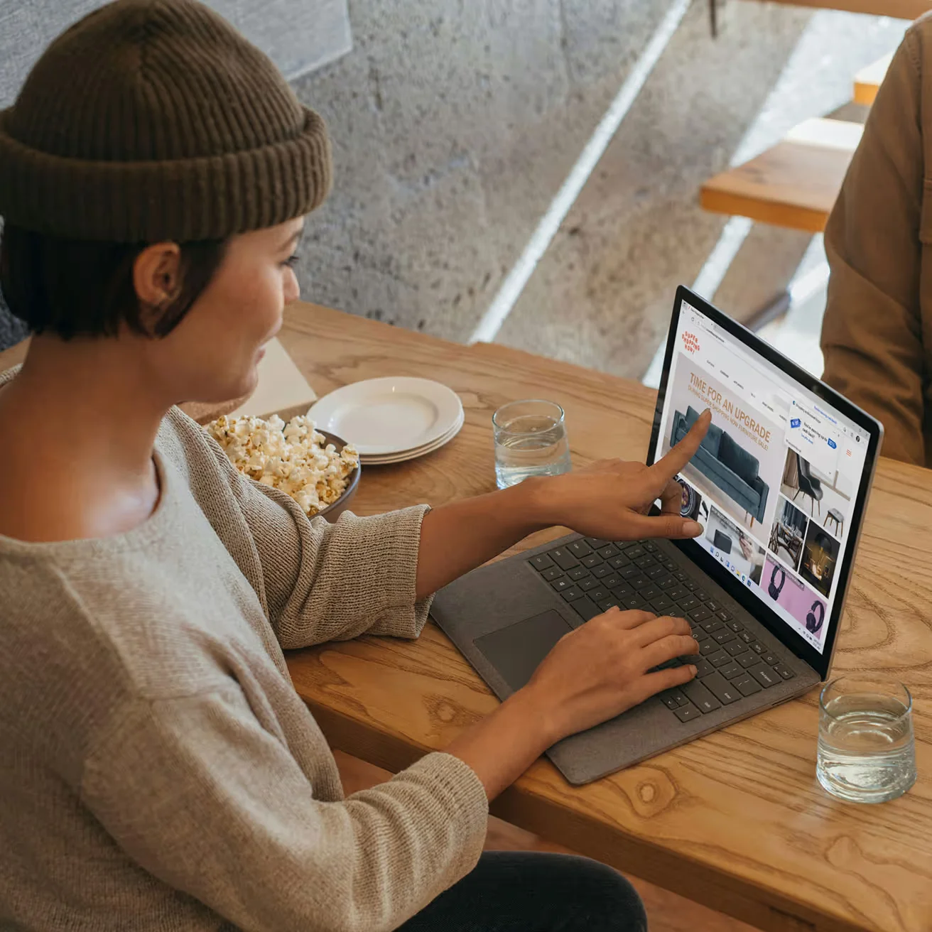 Woman shopping for home furniture online on laptop