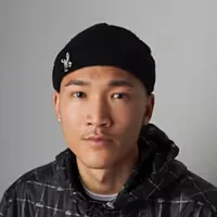 Man wearing a black beanie with a small logo